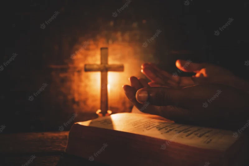 Vintage photo of hand with bible praying Free Photo