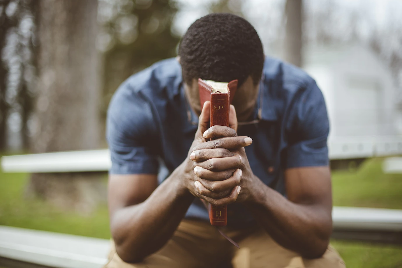 Young African American Male Sitting With Closed Eyes With Bible His Hands 181624 24395