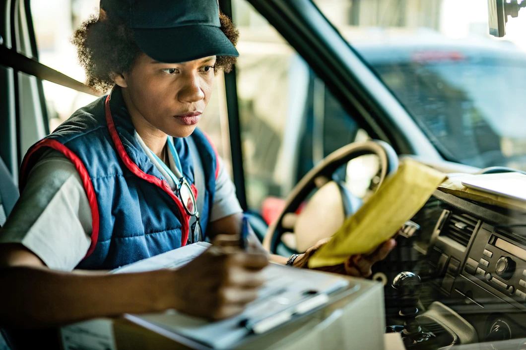 African American Delivery Woman Checking Address Package Taking Notes While Sitting Van 637285 1250