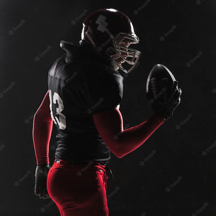 American Football Player Posing With Ball Black Background 155003 14577