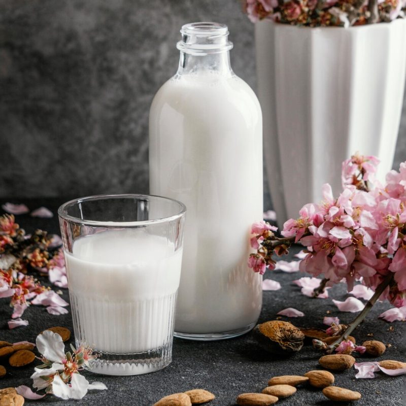 Arrangement of almond milk on the table Free Photo