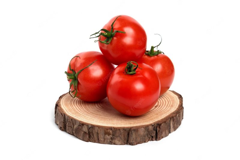 Big red fresh tomatoes on a wooden board. Free Photo