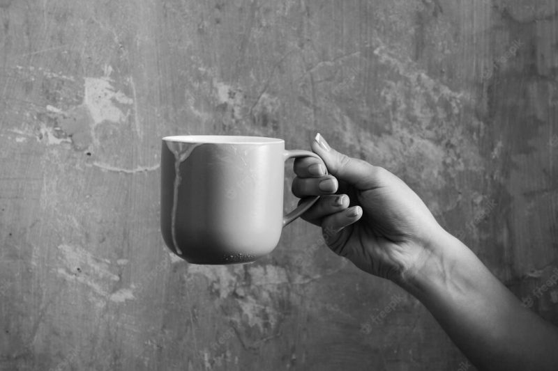 Blue cup with kefir in female hand Premium Photo