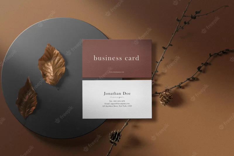 Clean minimal business card mockup on box with dry leaves Free Psd