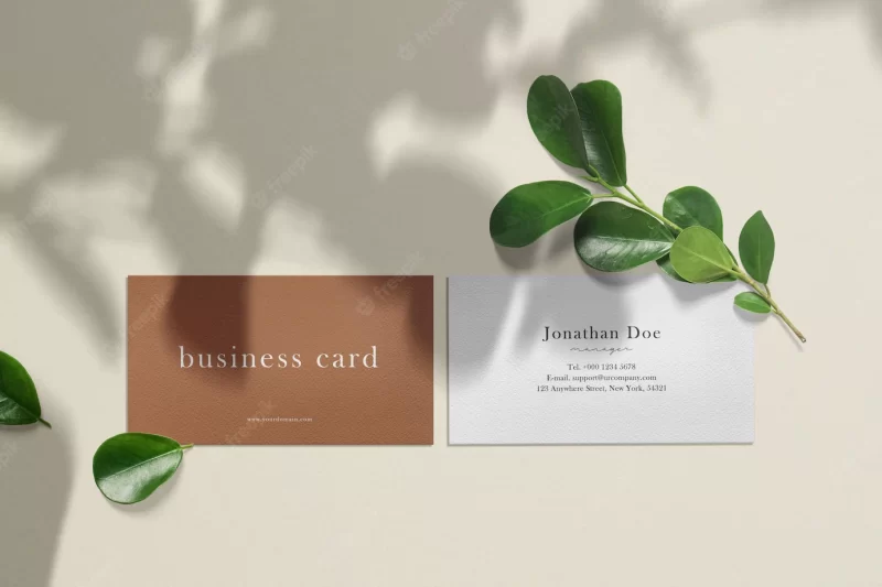 Clean minimal business card mockup on texture with leaves. Free Psd