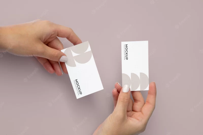 Close up hands holding business card above view Free Psd