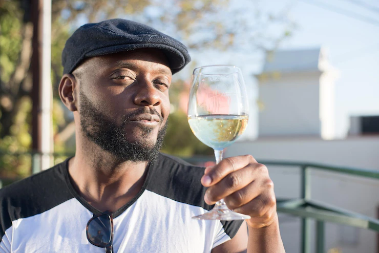 Close Up Happy African Man Holding Glass Wine Young Handsome Man Black Cap Tasting Drinking Wine Looking Camera City Blue Sky Background Celebration Dating Happy Moments Concept 74855 21493