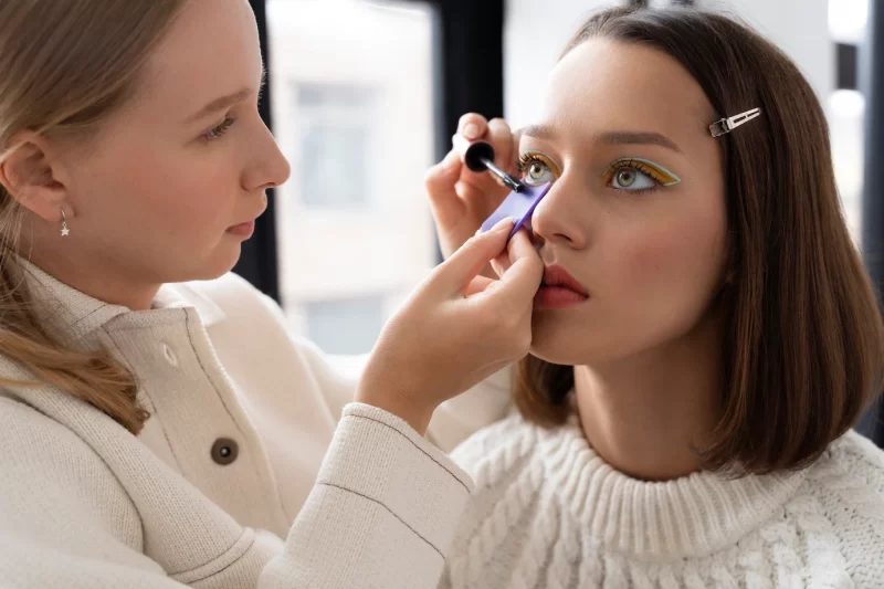 Close up woman applying mascara Free Photo