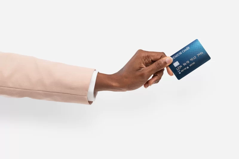 African American hand holding Credit card finance held by a hand for banking campaign Free Photo