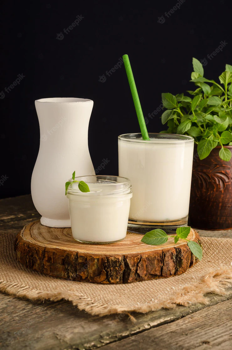 Dairy starter culture for the preparation of fermented milk products, yogurt, kefir in a glass on a wooden cut Premium Photo