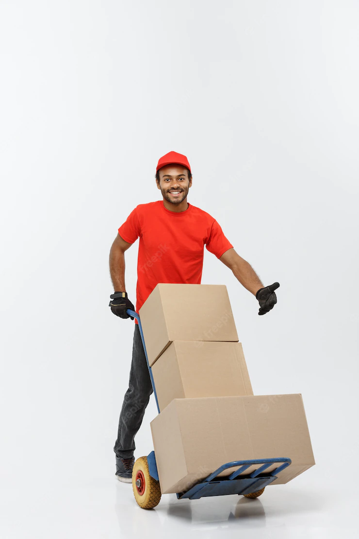 Delivery Concept Portrait Handsome African American Delivery Man Courier Pushing Hand Truck With Stack Boxes Isolated Grey Studio Background Copy Space 1258 1237