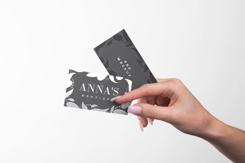 Embossed business card held in hand Free Psd