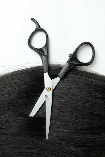 Female hair with scissors on white background Free Photo