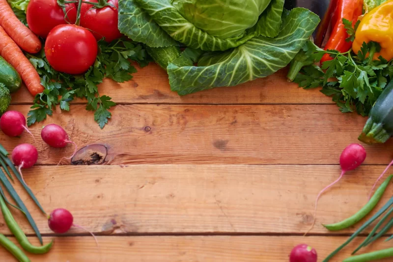 Fresh organic vegetables on a wooden boards background, top view. healthy food concept. Free Photo