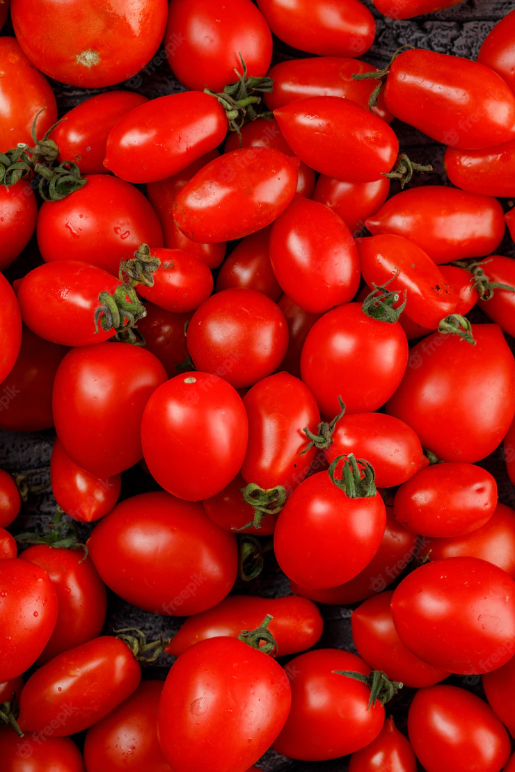 Fresh red tomatoes close-up on a wooden wall Free Photo