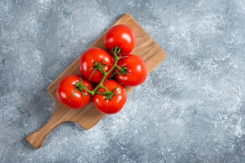 Fresh red tomatoes on wooden board. Free Photo