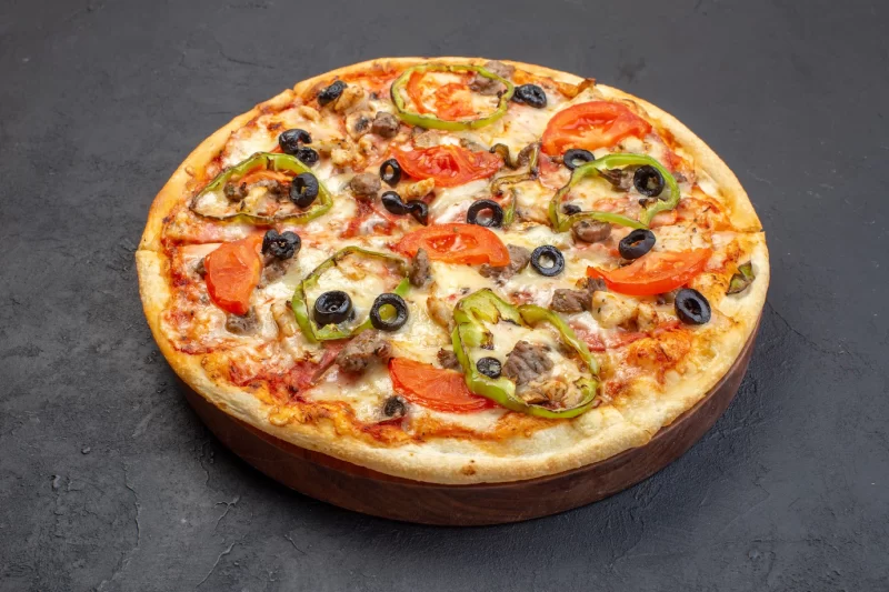 Front view delicious cheese pizza consists of olives pepper and tomatoes on dark surface Free Photo