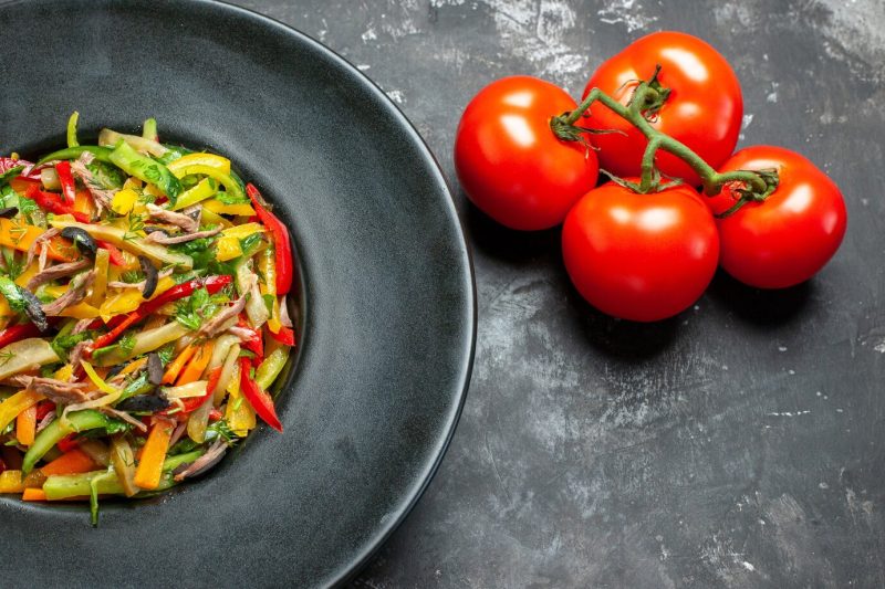 Front view tasty vegetable salad with fresh tomatoes on light-grey table Free Photo