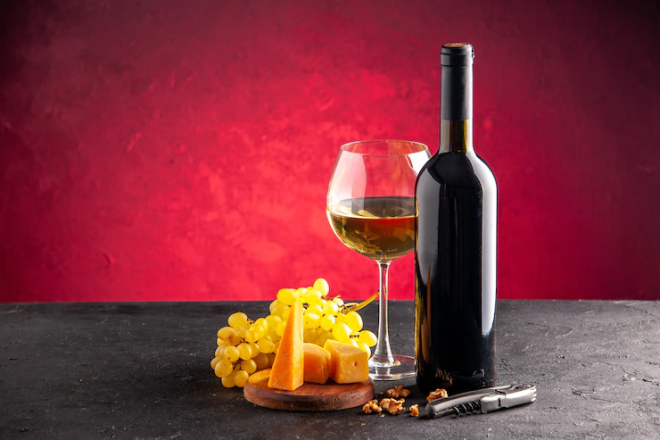 Front View Wine Glass Wine Bottle Yellow Grapes Cheese Wood Board Wine Opener Dark Table Light Red Background 140725 145005