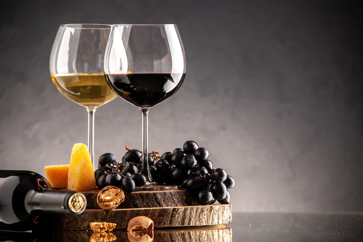 Front View Wine Glasses Fresh Grapes Walnuts Yellow Cheese Wood Board Overturned Bottle Dark Background 140725 144998