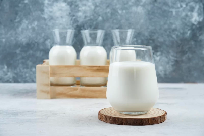 A glasses of milk on a gray table. Free Photo