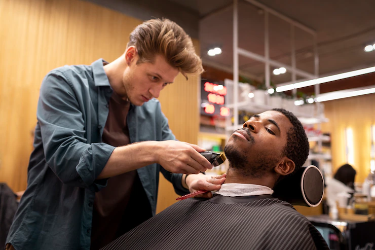 Hairdresser grooming their client Free Photo