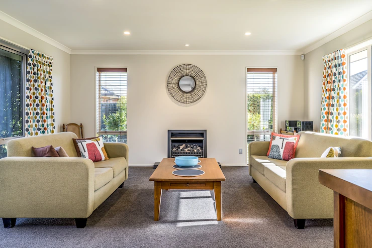 Living room of a modern apartment with two identical sofas opposite each other Free Photo