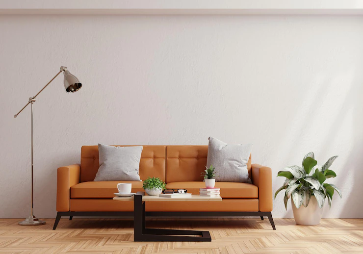 Living room wall mock up with leather sofa and decor on white plaster wall background3d rendering Free Photo