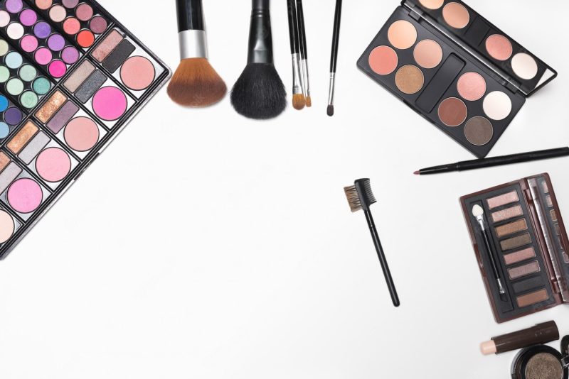 Makeup cosmetics and brushes on white background with copy space for text Free Photo