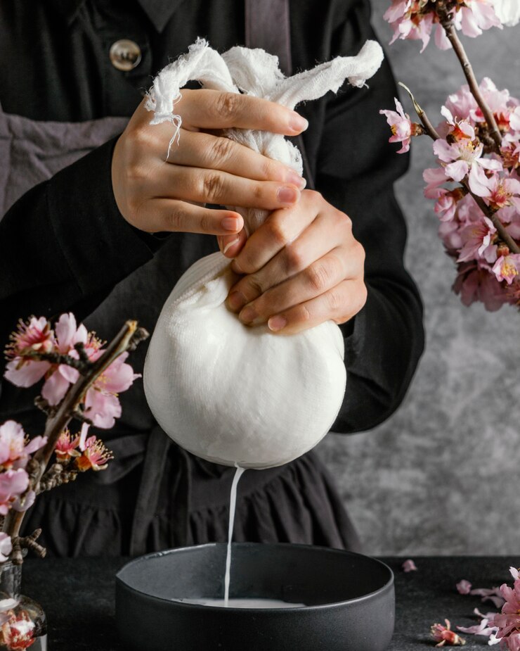 Person making almond milk Free Photo