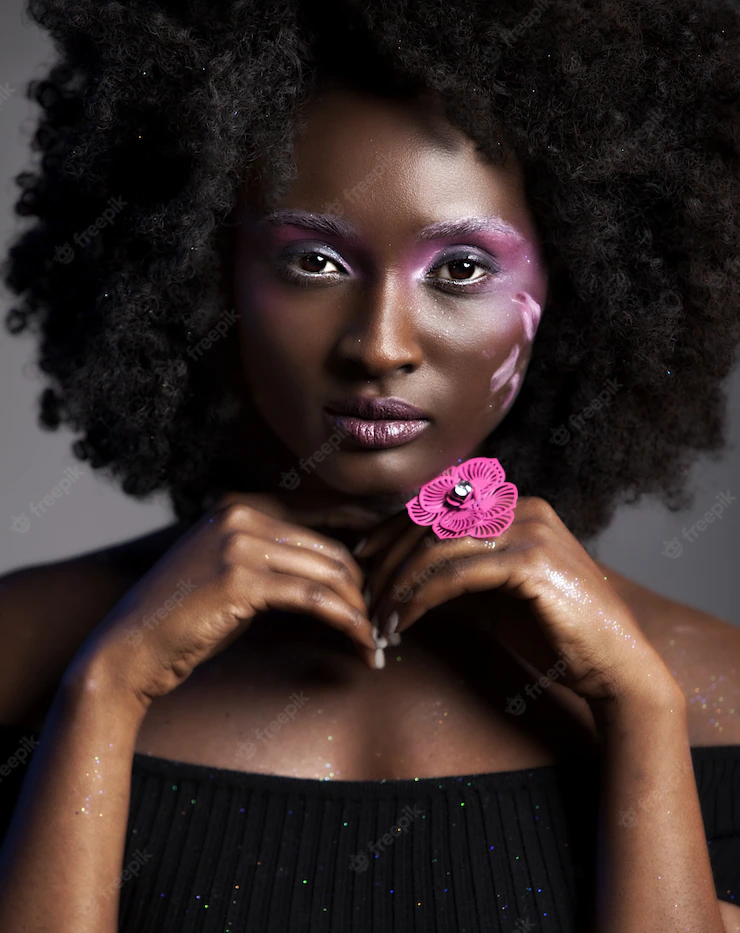 Portrait of a pretty african-american female with beautiful makeup wearing a flower ring Free Photo