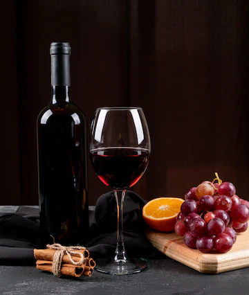 Side View Red Wine With Grape Orange Wooden Cutting Board Dark Vertical 176474 4138