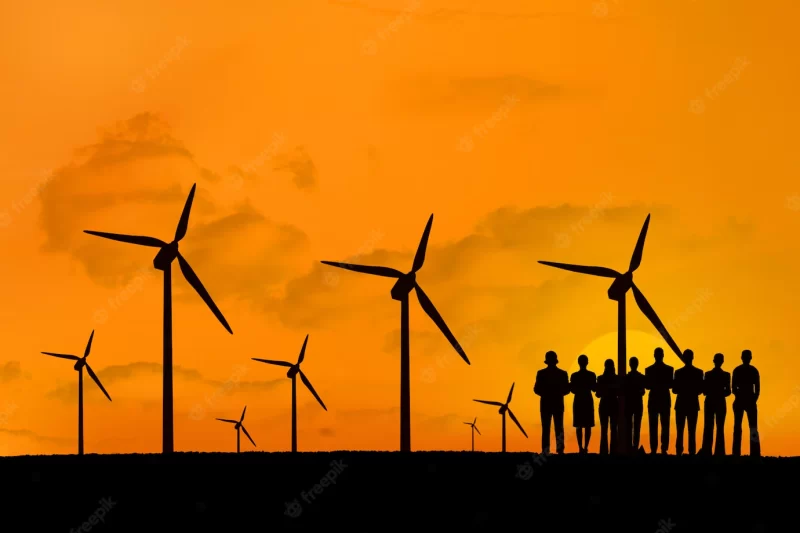 Silhouette of people enjoying the renewable energy Free Photo