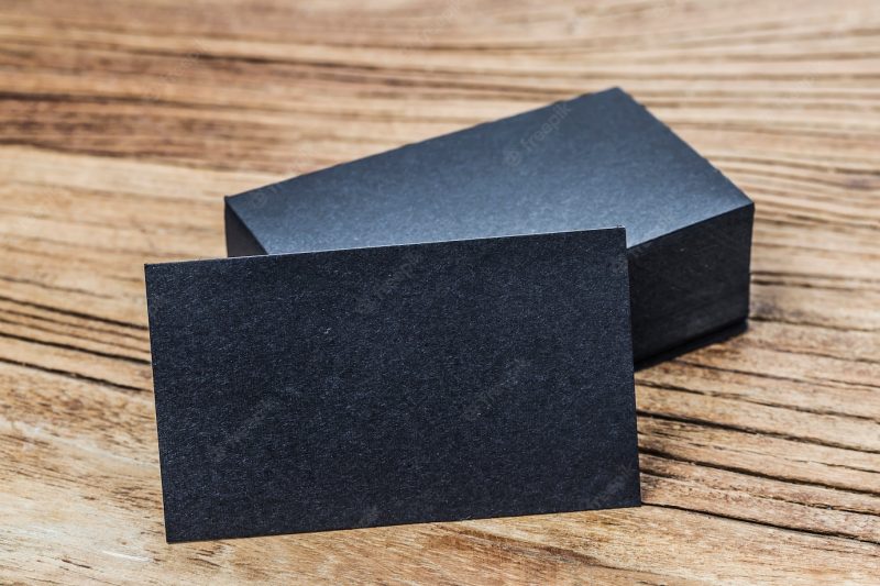 Stack of blank black business cards on wooden background Free Photo