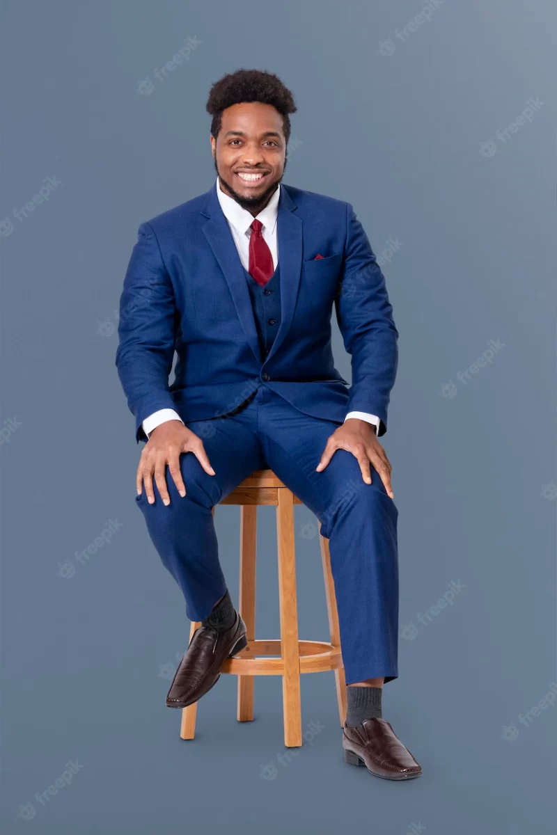 Successful African black businessman sitting on a wooden stool jobs and career campaign Free Photo