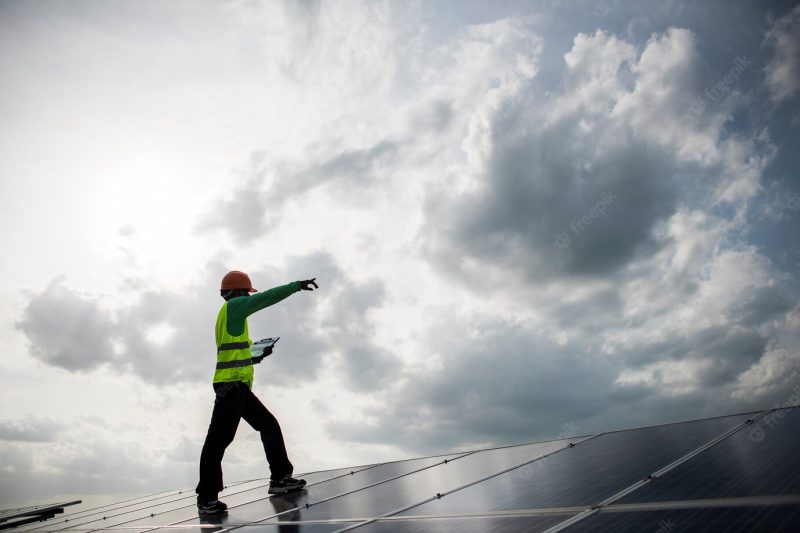 Technician engineer checks the maintenance of the solar cell panels. Free Photo