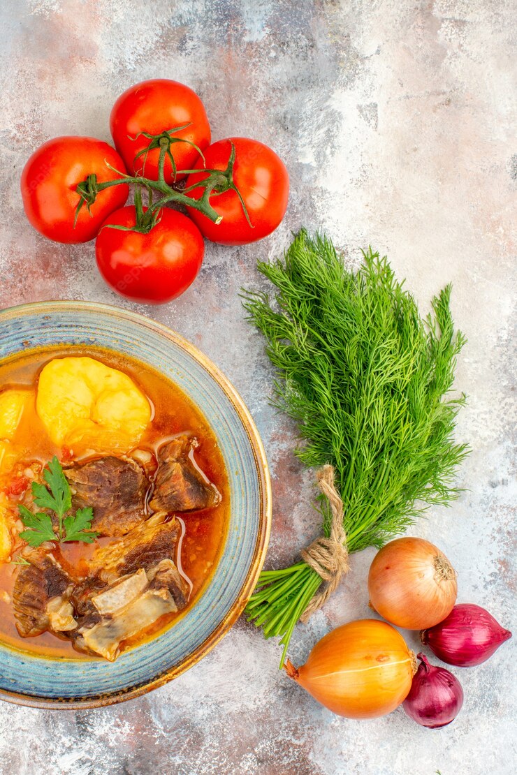 Top view homemade bozbash soup a bunch of dill tomatoes onions on nude background Free Photo