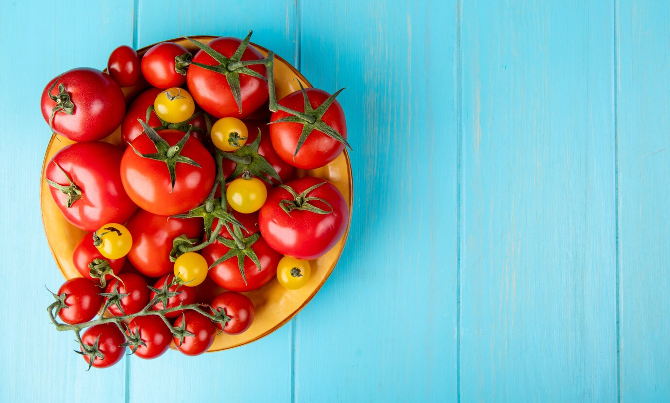 Top View Tomatoes Bowl Left Side Blue Surface With Copy Space 141793 10225