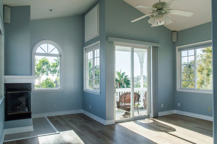 Trendy modern interior of a living room with blue walls and white windows Free Photo