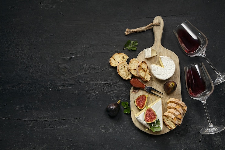 Two Glasses Red Wine Tasty Cheese Plate With Fruit Toasted Bread Wooden Kitchen Plate Black Stone Background Top View Copy Space Gourmet Food Drink 155003 36440