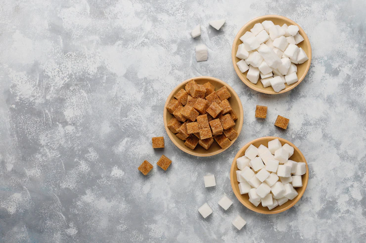 Various types of sugar, brown sugar and white on concrete ,top view Free Photo