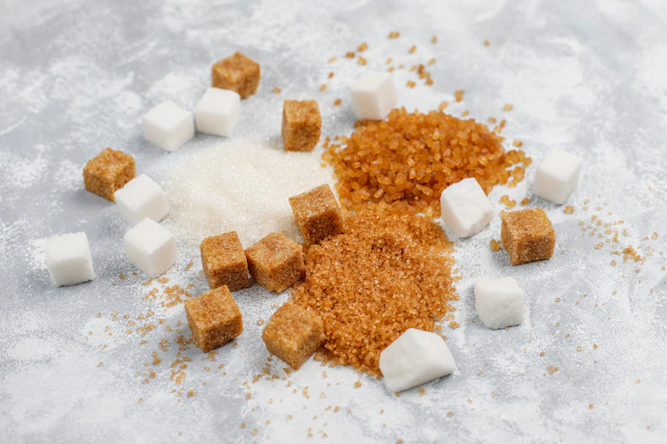 Various types of sugar, brown sugar and white on concrete ,top view Free Photo