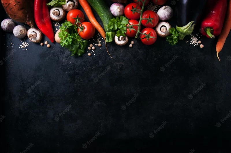 Various vegetables on a black table with space for a message Free Photo