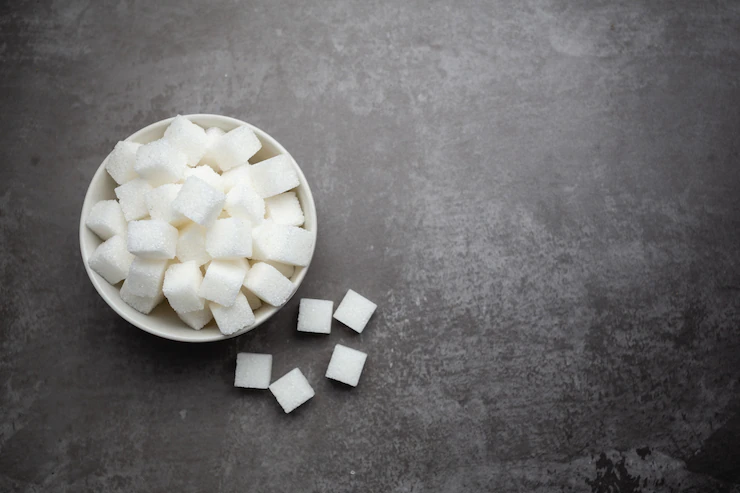 White sugar cubes in bowl on table. Free Photo