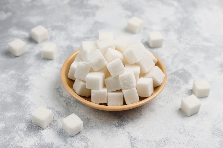 White sugar cubes on concrete ,top view Free Photo