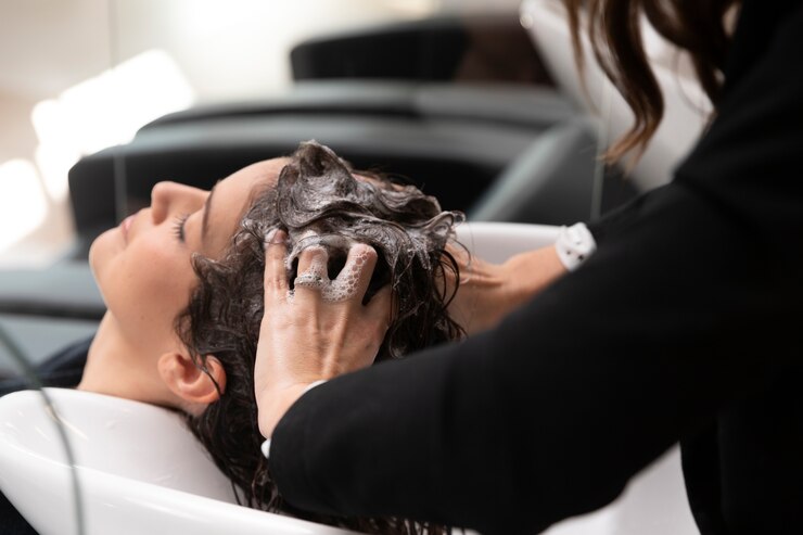 Woman getting treatment at hairdresser shop Free Photo