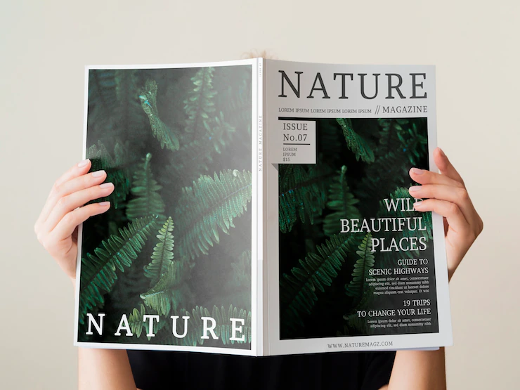 Womans Hand Holding Nature Magazine Mock Up 23 2148311942