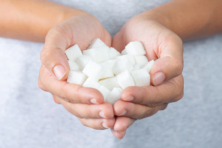 World diabetes day; hand holding sugar cubes Free Photo