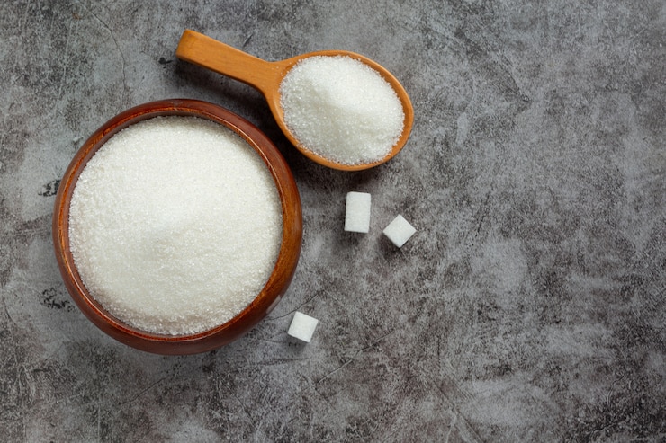 World diabetes day; sugar in wooden bowl on dark background Free Photo