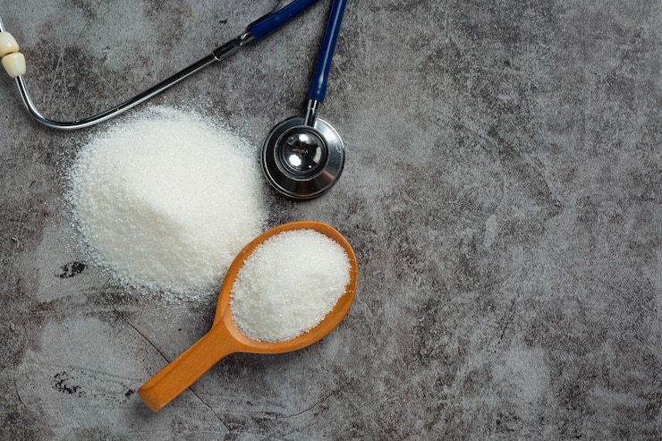 World diabetes day; sugar in wooden bowl and stethoscope on dark background Free Photo